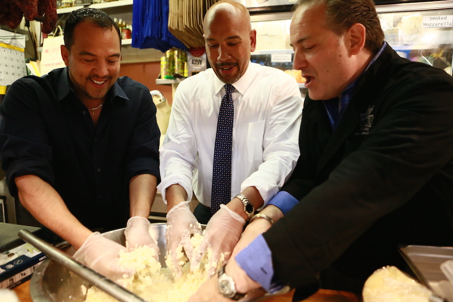 Ruben Diaz making fresh mozzarella with David Greco, owner of Mikes Deli in the Arthur Avenue Retail Market. 