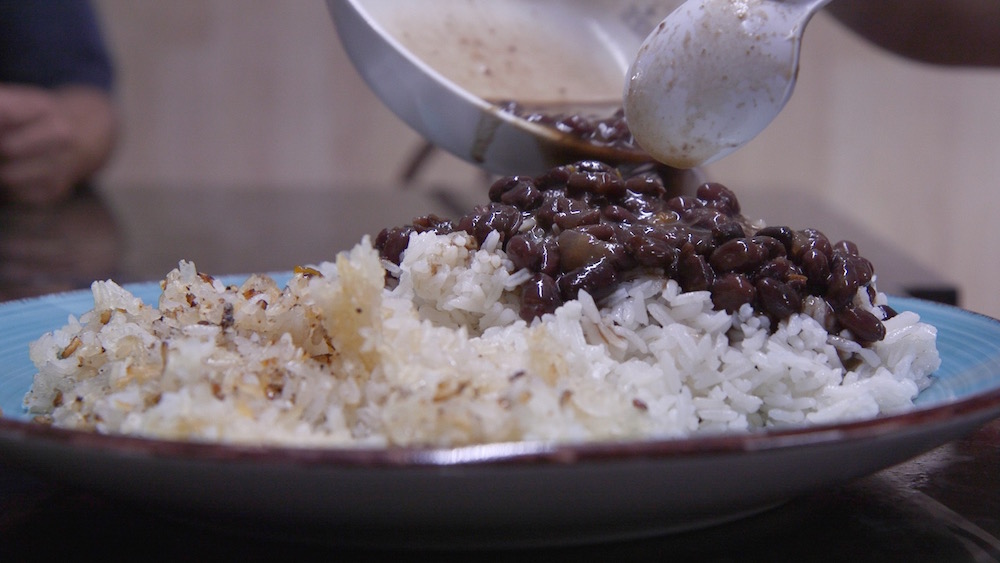 Black Beans poured over white rice and concon, cripsy rice found at the bottom of the pan