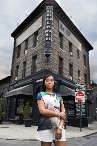 Restaurant owner Rosa Gracia stands in front of her business Mott Haven Bar & Grill