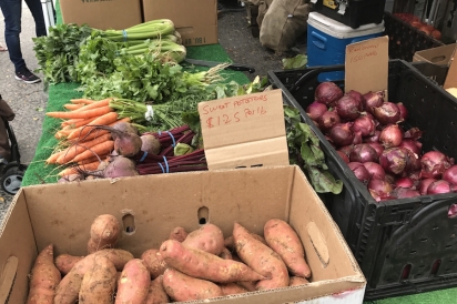 Sweet potatoes and red onions for sale at the farmers market