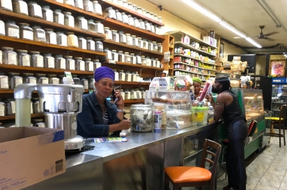 Co-Owner Syble Compton stands behind the counter at H.I.M