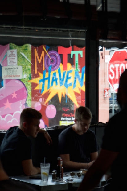 Colorful Mott Haven mural as seen from inside the restaurant 